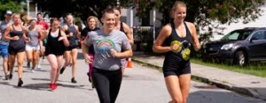 A group of people running down the street.